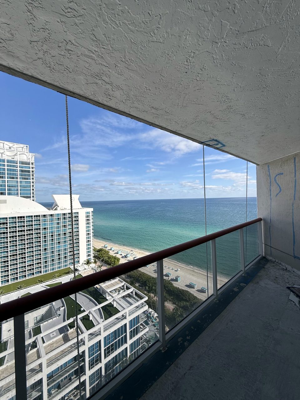 Glass balcony railing with ocean view